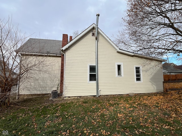 view of property exterior featuring a yard and central air condition unit