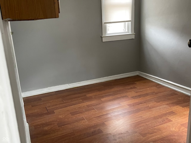 empty room featuring dark wood-type flooring