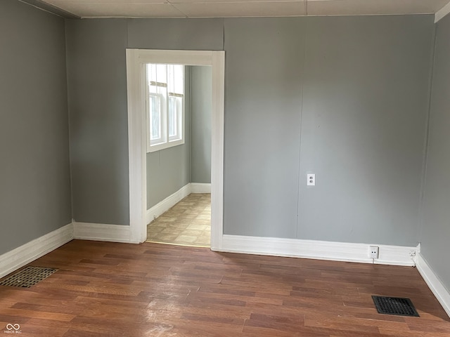 unfurnished room featuring hardwood / wood-style flooring