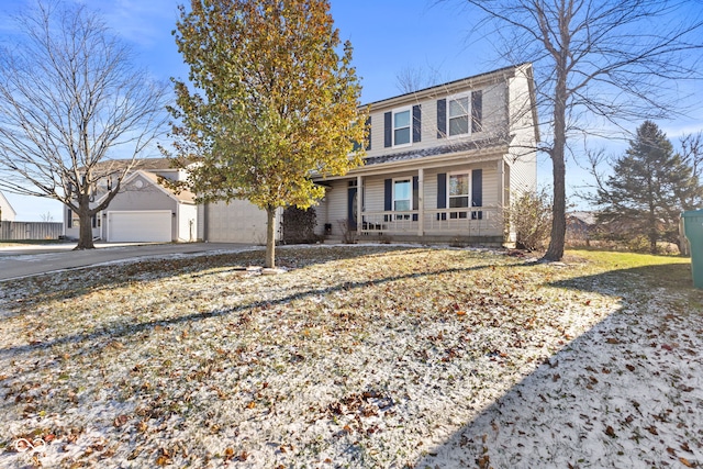 view of property with covered porch and a garage