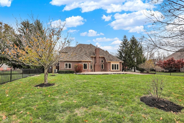 rear view of property with a yard and a patio