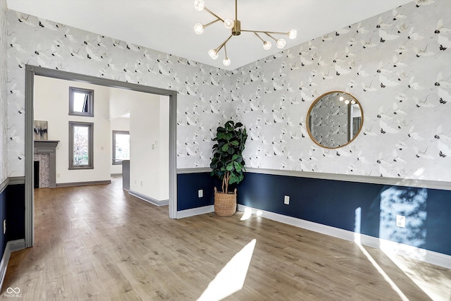 interior space with wood-type flooring and a notable chandelier