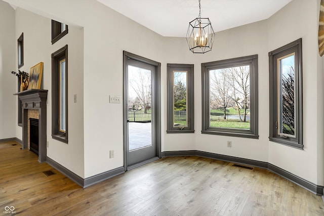 interior space with a notable chandelier and light wood-type flooring