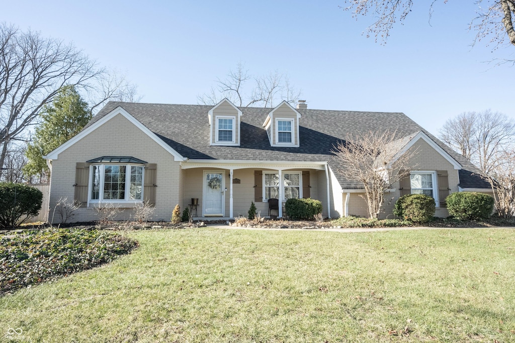 new england style home featuring a front yard