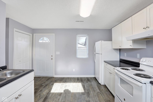 kitchen with white cabinets, dark hardwood / wood-style flooring, white appliances, and a textured ceiling