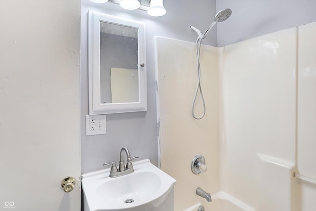 bathroom featuring shower / bathing tub combination and sink