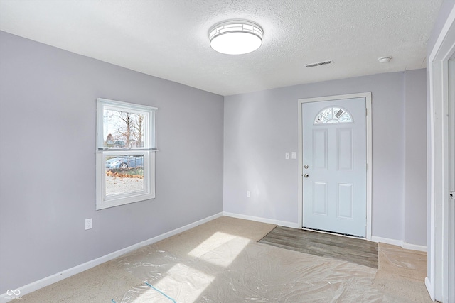 foyer with a textured ceiling