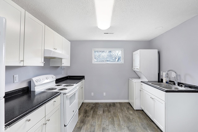 kitchen featuring white cabinetry, sink, white range with electric cooktop, stacked washer / dryer, and hardwood / wood-style flooring