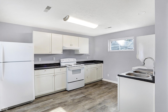 kitchen featuring sink, white cabinets, and white appliances