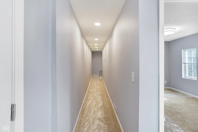 corridor featuring light carpet