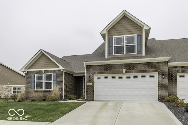 view of front of house featuring a garage and a front lawn