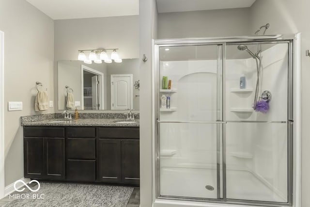 bathroom featuring vanity, an enclosed shower, and hardwood / wood-style flooring