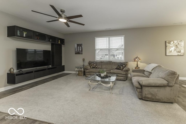 living room with wood-type flooring and ceiling fan