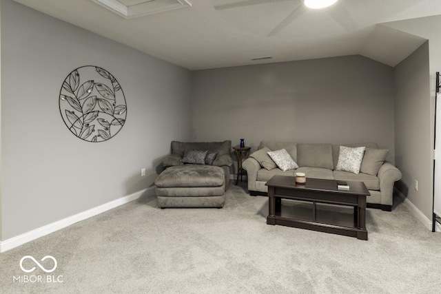 carpeted living room featuring ceiling fan and vaulted ceiling