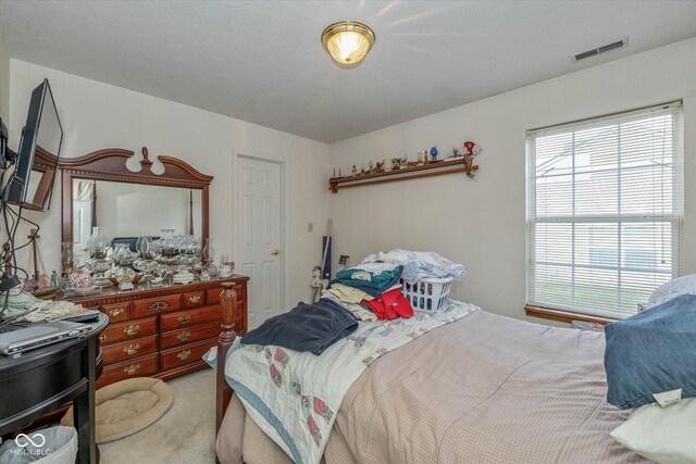 bedroom with light carpet