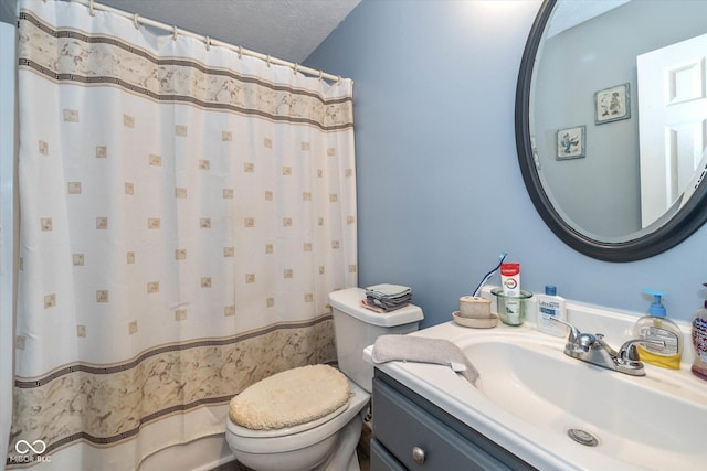 bathroom featuring vanity, toilet, and a textured ceiling