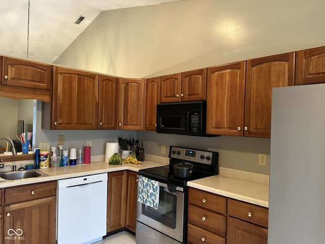 kitchen featuring white appliances, sink, and vaulted ceiling