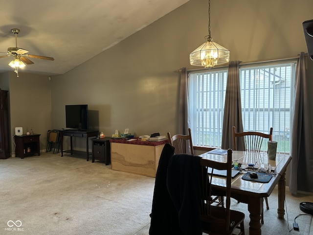 dining area featuring carpet, ceiling fan with notable chandelier, and high vaulted ceiling