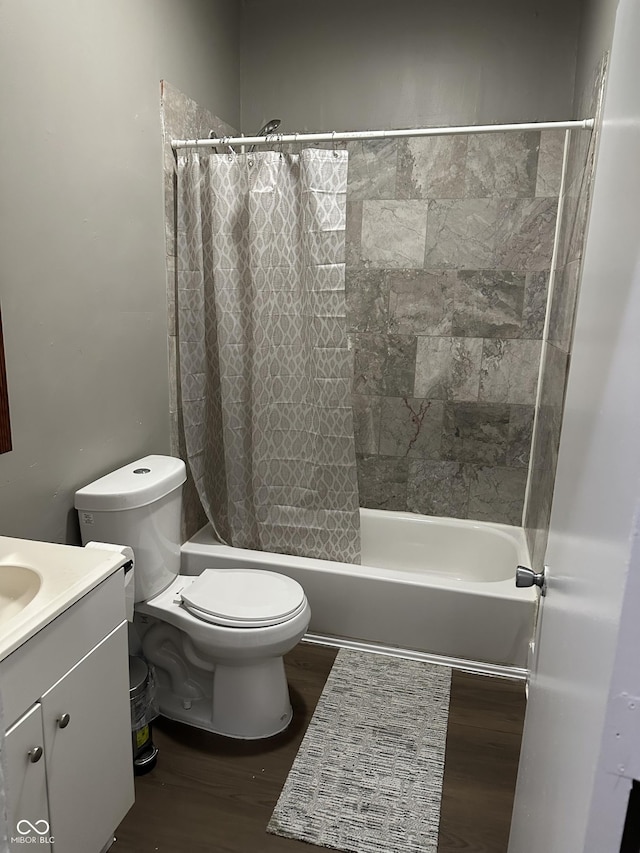 full bathroom featuring hardwood / wood-style flooring, vanity, toilet, and shower / bath combo