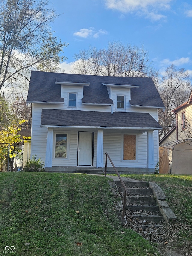 view of front of property with a porch and a front yard