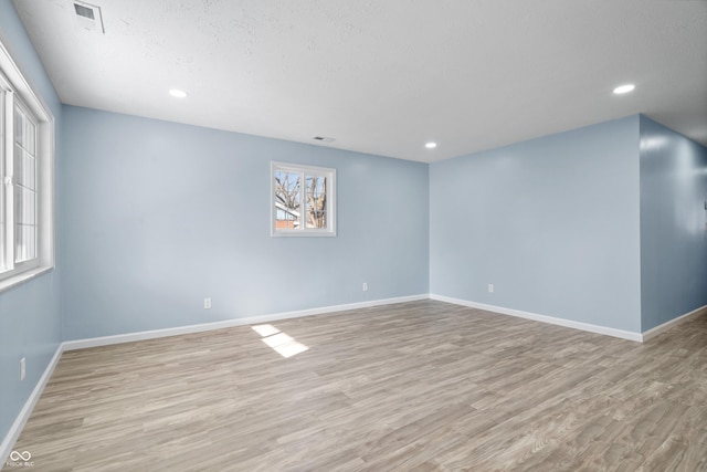 spare room featuring light wood-type flooring