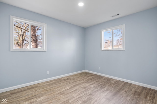 unfurnished room featuring light hardwood / wood-style floors