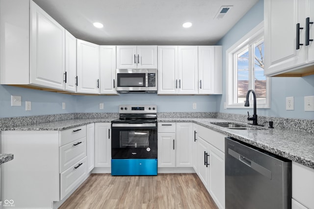 kitchen featuring white cabinetry and appliances with stainless steel finishes