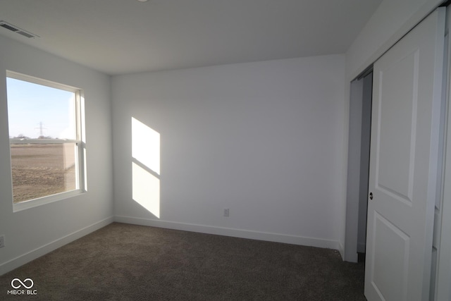 carpeted empty room featuring plenty of natural light