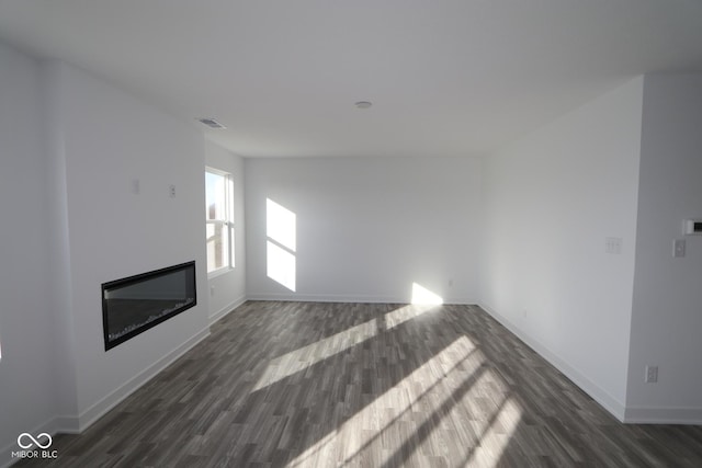 unfurnished living room featuring dark hardwood / wood-style floors