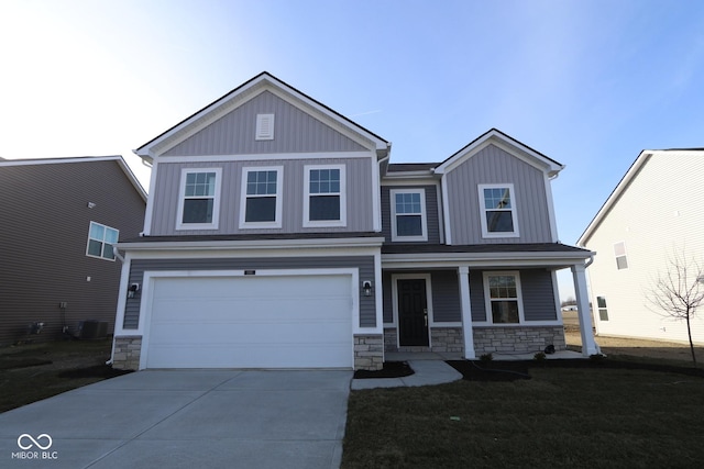 view of front facade with covered porch, a garage, a front lawn, and central AC