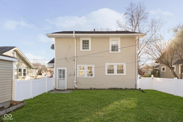 rear view of house with a lawn