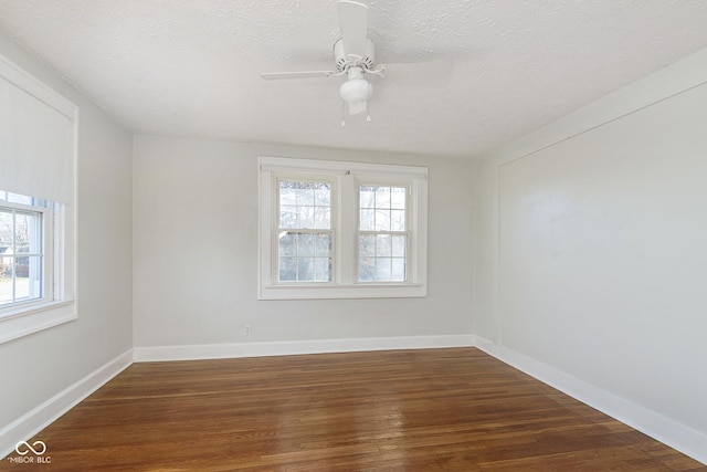 spare room with ceiling fan, dark hardwood / wood-style flooring, and a textured ceiling