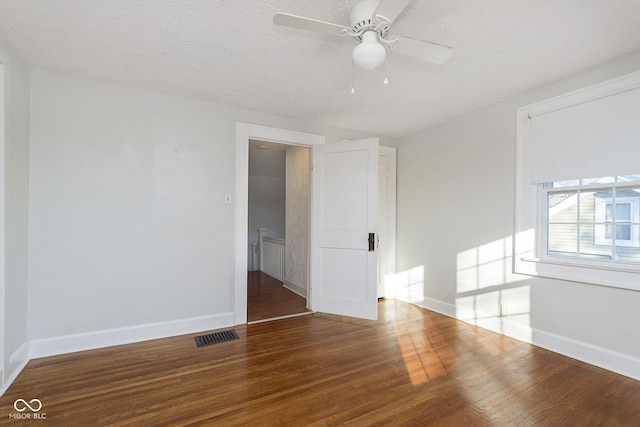 unfurnished room featuring a textured ceiling, hardwood / wood-style flooring, and ceiling fan