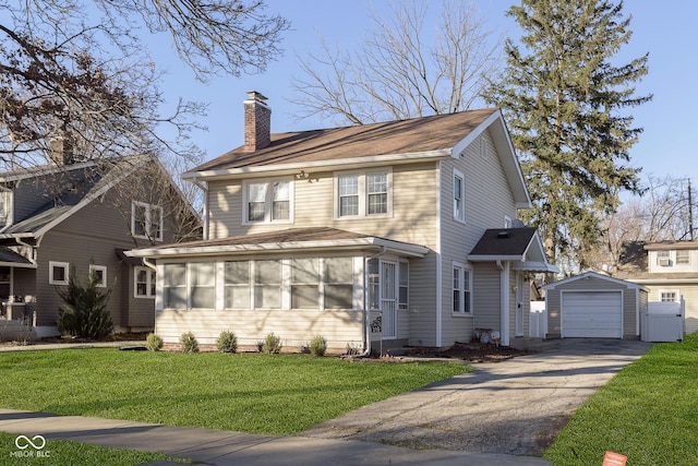 view of front property with a front yard, a garage, an outdoor structure, and a sunroom