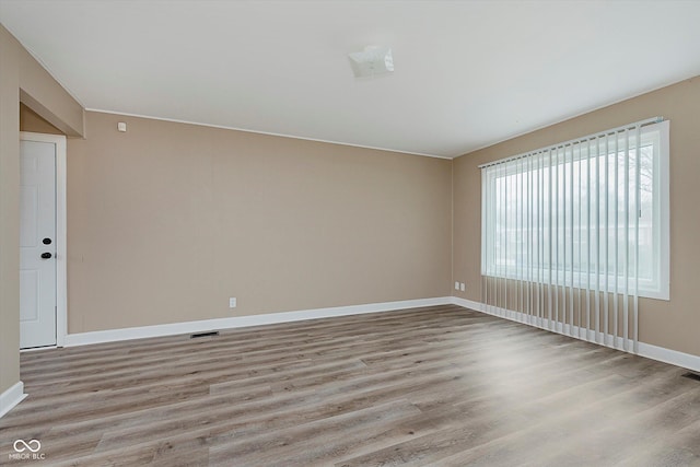 unfurnished room with light wood-type flooring