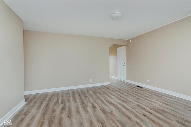 spare room featuring light hardwood / wood-style flooring