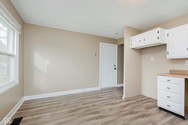 kitchen with white cabinets and light wood-type flooring