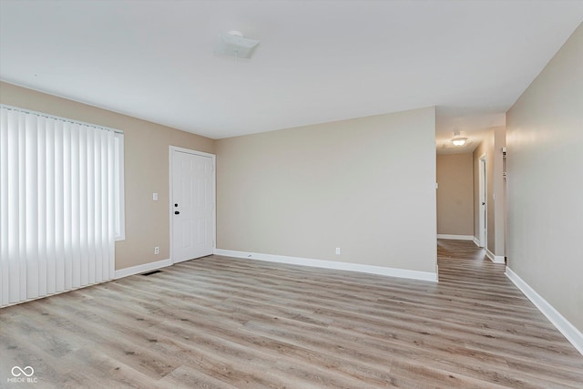 spare room featuring light wood-type flooring