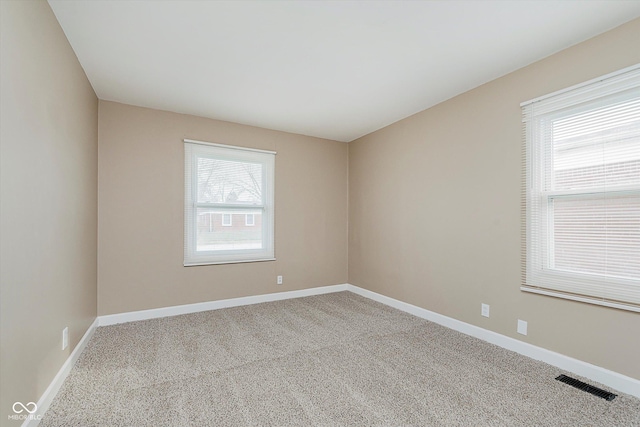 empty room featuring light carpet