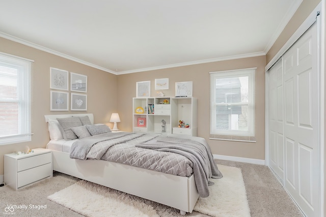 carpeted bedroom with multiple windows, a closet, and ornamental molding