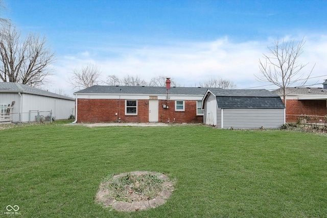 rear view of house with an outbuilding and a lawn