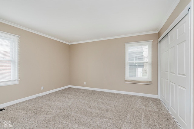 unfurnished bedroom featuring multiple windows, a closet, carpet, and ornamental molding