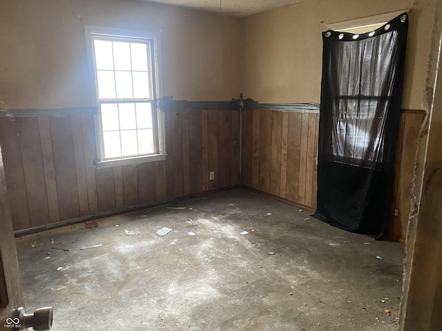 empty room featuring wooden walls