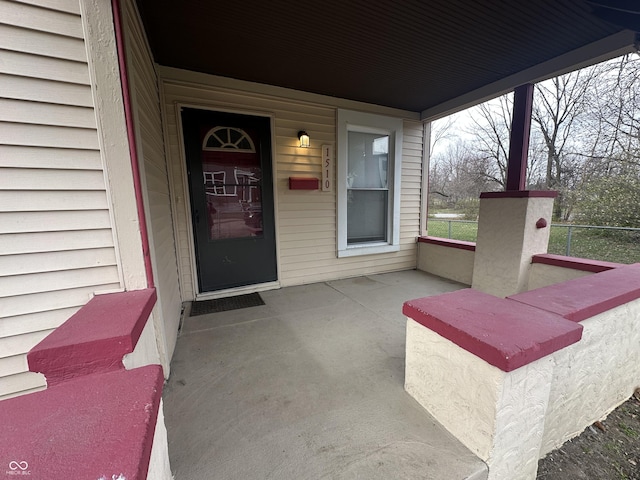 view of exterior entry with a porch