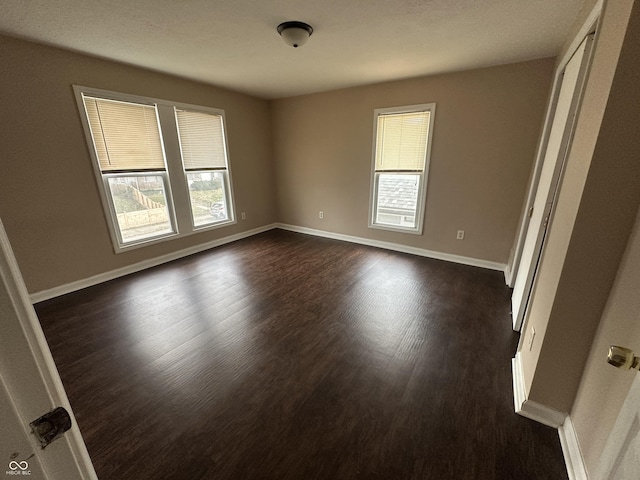 unfurnished room featuring dark wood-type flooring