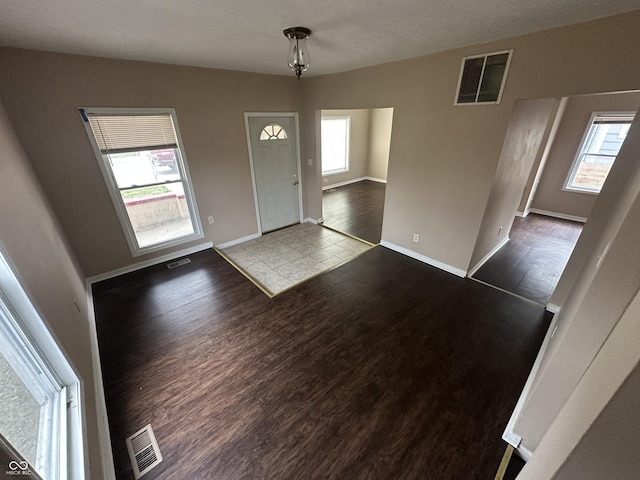 foyer entrance featuring hardwood / wood-style floors and plenty of natural light