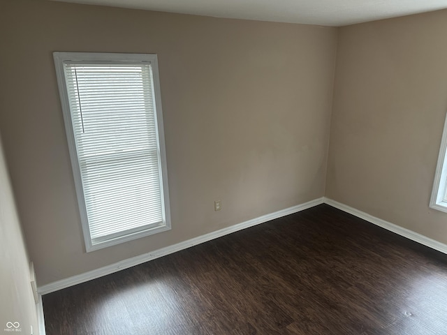 unfurnished room featuring dark hardwood / wood-style floors