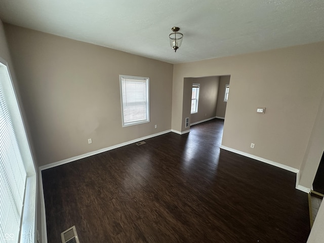 unfurnished room with dark hardwood / wood-style floors