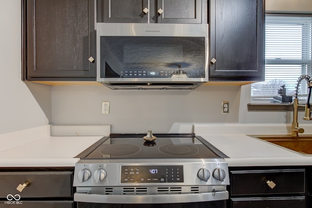 kitchen featuring dark brown cabinets and appliances with stainless steel finishes