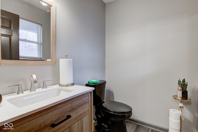 bathroom featuring vanity, toilet, and wood-type flooring